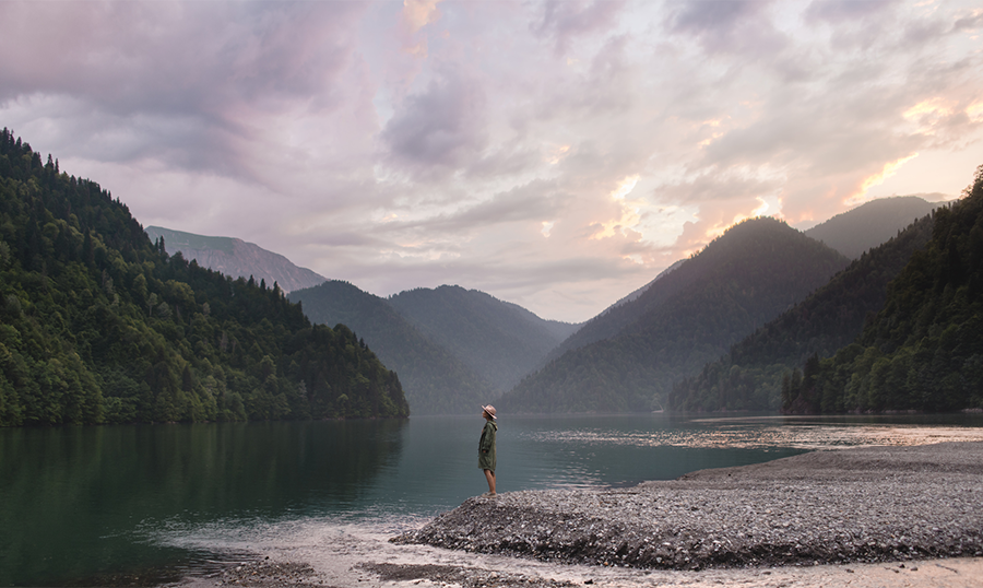 Woman standing by a river loving-kindness