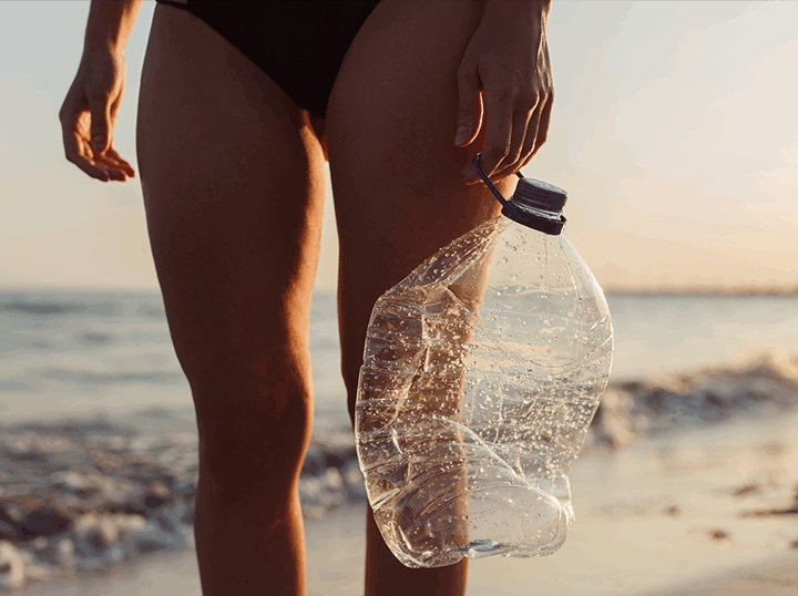 Woman holding plastic bottle trash