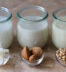 Various types of vegan milk in jars (coconut milk,almond milk,soya milk)