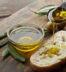 slice of bread seasoned with olive oil on wooden background