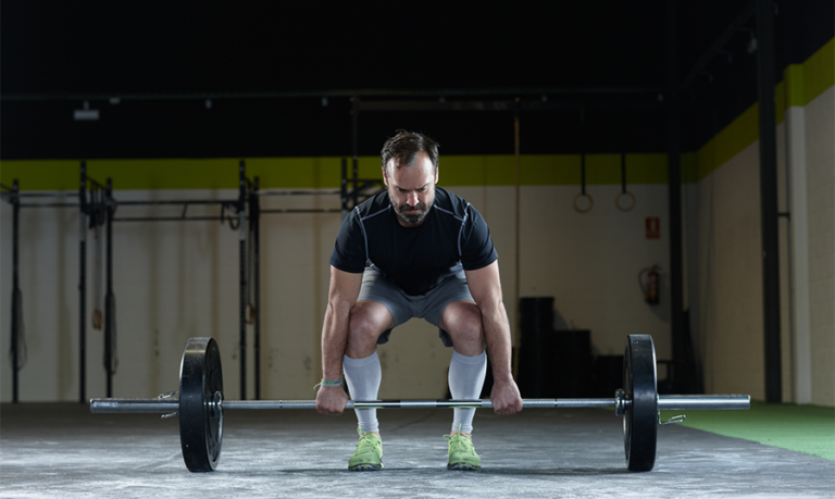 man lifting weights