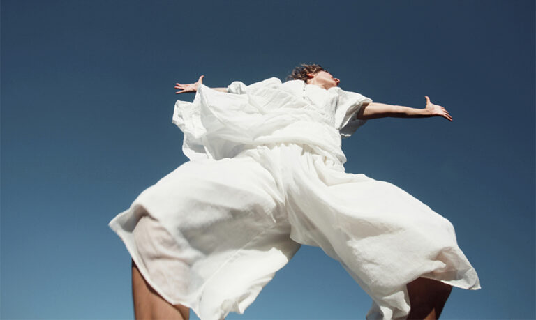 Girl in white is moving in the sky