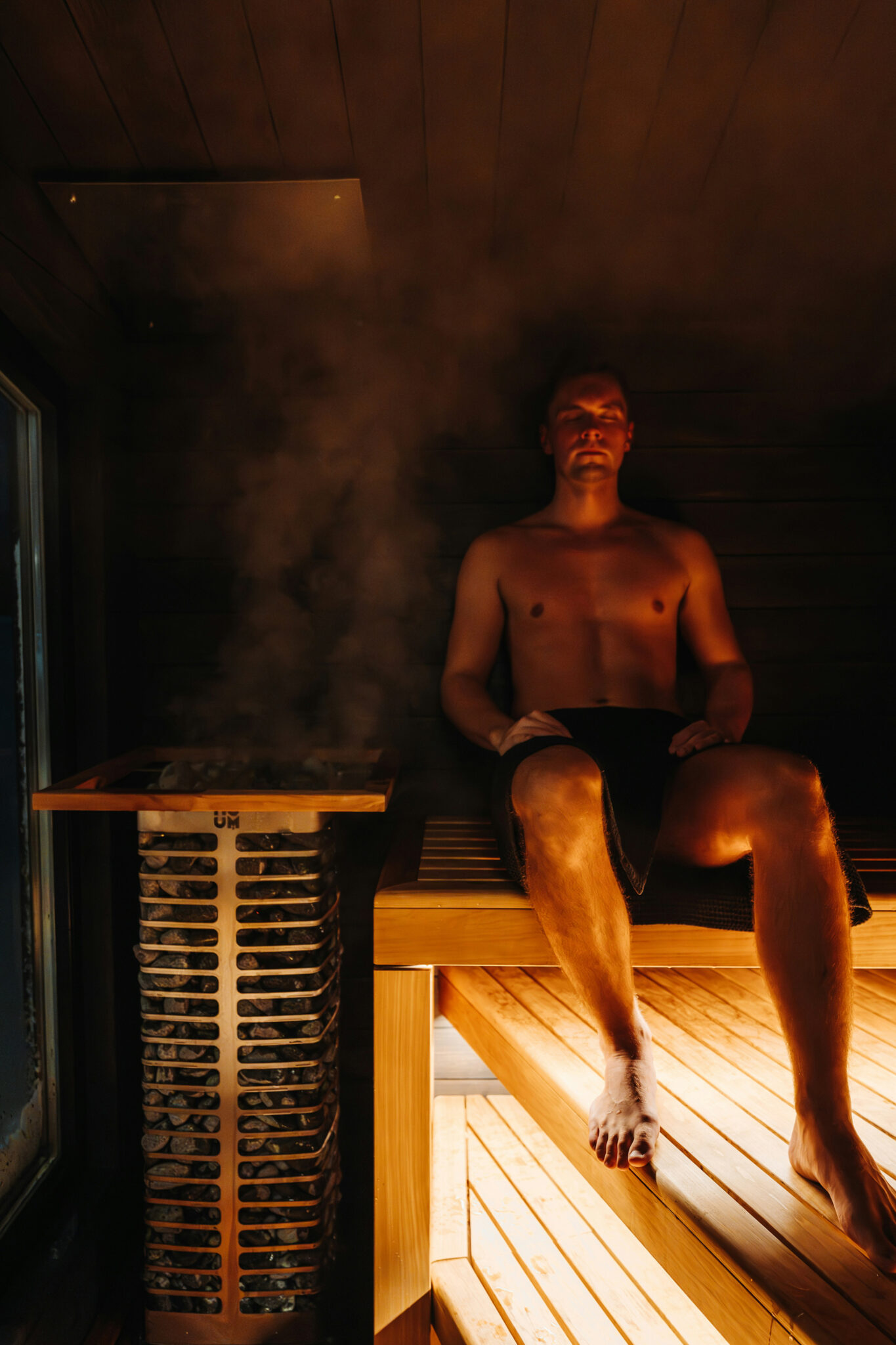 Man resting in a wooden sauna