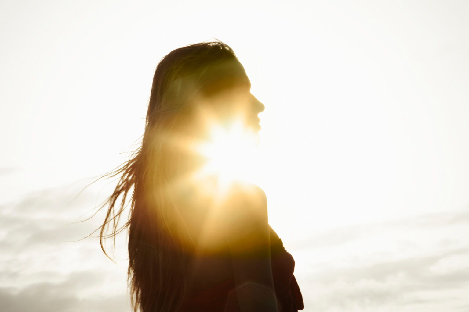 Woman in profile, backlit by the sun